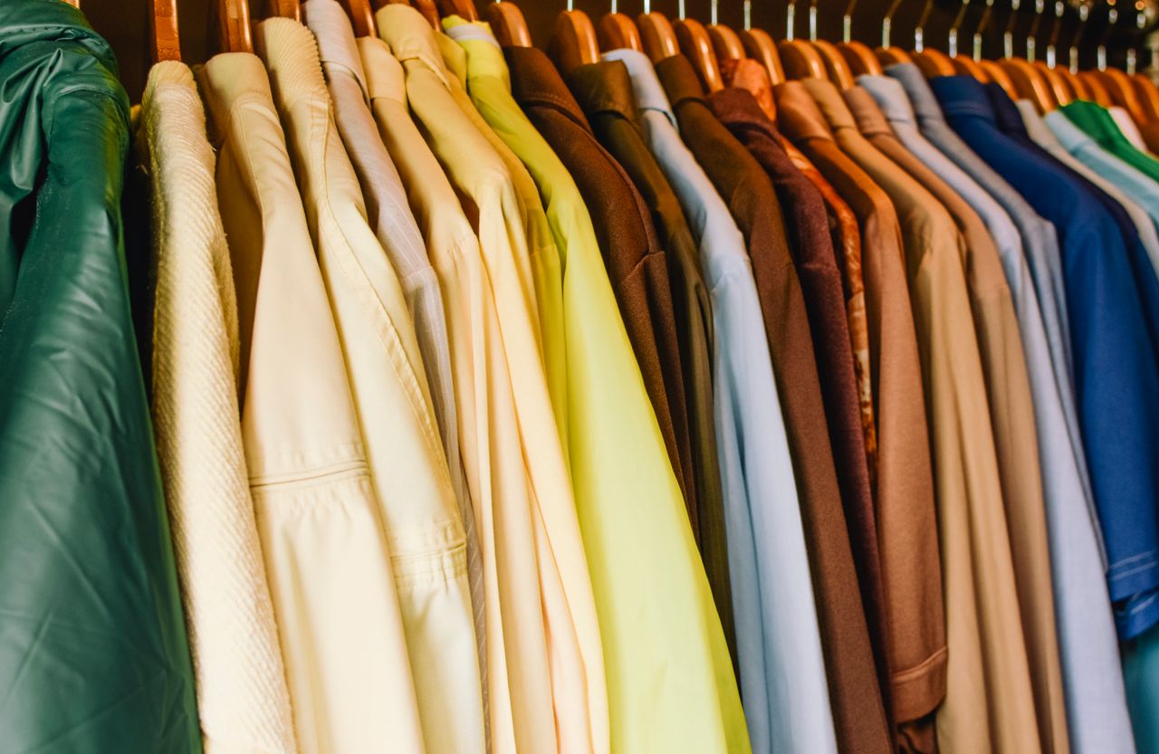 brand-03 A vibrant selection of shirts and jackets in a wardrobe, perfect for fashion concepts.